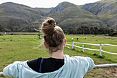 Teenage girl looking at horses, Stanford, South Africa