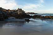A deserted beach, jagged rocks and rockpools on the Atlantic coast,  South Africa