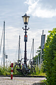 Bicycles at Schellingwouderdijk, historic street lamp, Amsterdam, North Holland, Netherlands