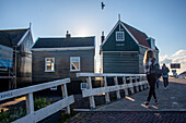 Characteristic wooden houses, bridge, people walking, Marken peninsula, near Amsterdam, North Holland, Netherlands