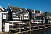 Characteristic wooden houses, souvenir shop, harbour, Marken Peninsula, near Amsterdam, North Holland, The Netherlands