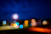 Cityscape with Bokeh and The Moon in Lugano, ticino, switzerland.