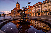 Market square with Neptune Fountain and Gaukirche in Paderborn in the evening light, North Rhine-Westphalia, Germany