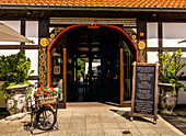 Entrance to a restaurant in a historic half-timbered house on Sälzerplatz in Bad Sassendorf, Soest district, North Rhine-Westphalia, Germany