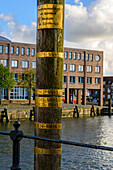 Husum inland port Storm flood water levels on wooden post, Husum, North Friesland, North Sea coast, Schleswig Holstein, Germany, Europe