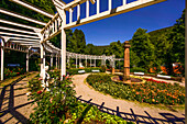 Rosarium with round pergola, fountain column and antique figures by Joseph Kopf in the spa gardens of Bad Wildbad, Baden-Württemberg, Germany