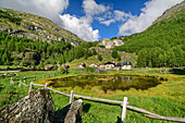 Pond with alpine settlement Le Monal, Rutor Group, Graian Alps, Savoy, Savoie, France