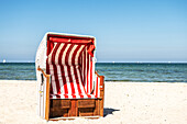 Red and white striped beach chair on the Baltic Sea beach, Baltic Sea, Ostholstein, Schleswig-Holstein, Germany