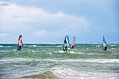 Surfers in front of the Fehmarn Sund Bruecke, Heiligenhafen, Baltic Sea, Ostholstein, Schleswig-Holstein, Germany