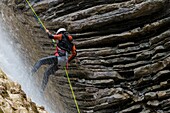 Climber descending a ravine,Broto,Pyrenees,Spain.