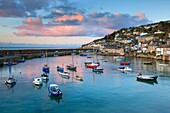 The picturesque harbour at Mousehole on the western side of Mount's Bay in Cornwall. The image was captured at sunrise on a still morning in late April.