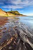 The Clavell Tower on Dorset's Jurassic Coast,captured from the waters edge in Kimmeridge Bay on an evening in early July.