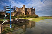 The medieval castle at Laugharne in Carmathernshire,catptured at high tide on a sunny evening in mid April.