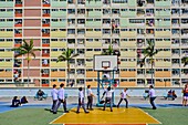 China,Hong Kong,Kowloon island,Densely crowded apartment buildings,students playing basketball.