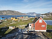 Small fishing village Ikerasak on Ikerask island in the Uummannaq Fjord System. America,North America,Greenland,Uummannaq.