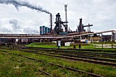 IJmuiden,Netherlands. Huge,heavy steel production plant and industry terrain,producing various kinds of steel inside an CO2 emitting factory. The steel plant is called Hoogovens and is owned by Tata Steel,an international corporation,who also suffers from decline in revenues and ever increasing demands on corporate responsibility,regarding labour and climate.