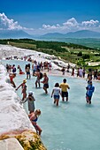 Tourists bathing in the travatine pools oand thermal waters of Pamukkale. Turkey.
