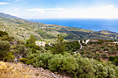 Coastal landscape overlooking the mountain village of Skoureika with serpentine road and Samiopoula island, Samos island in Greece