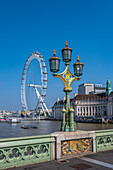 View of lamp post on Westminster Bridge with The London Eye, Westminster, London, England, United Kingdom, Europe