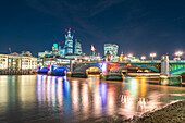 UK, London, Southwark Bridge and City of London at night