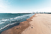 Spain, Valencia, Aerial view of beach and sea with port cranes in distance