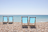 UK, Brighton, Deckchairs on beach