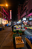 City street with local market stalls at nigh in Hong Kong