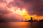 View of city skyline under the storm clouds during sunset, Hong Kong, China