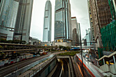 Traffic moving on bridge with modern skyscrapers in background, Hong Kong