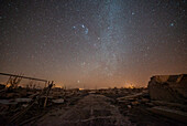 Scenic view of dirt road passing through abandoned village against milky way in sky, Villa Epecuen