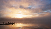 USA, New York, Lake Placid, Lake Placid reflecting sunlight and clouds at sunrise