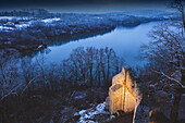 Poland, Lesser Poland, Dobczyce, Ruins of old castle in winter landscape by river