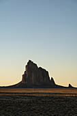 USA, New Mexico, Desert landscape with Ship Rock at sunset