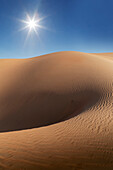 Dubai, United Arab Emirates, Sun shining over sand dunes in desert