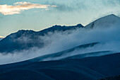 United States, Idaho, Sun Valley, Fog rolling over foothills at dusk