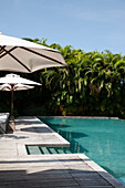 Cambodia, Hotel swimming pool with umbrellas