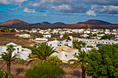 View of town from elevated position with mountainous backdrop, Yaisa, Lanzarote, Canary Islands, Spain, Atlantic, Europe