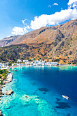 Aerial view of seaside village of Loutro nestled in the idyllic cove washed by turquoise sea, Crete island, Greek Islands, Greece, Europe