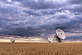 Radio telescopes of the Raisting earth station in front of picturesque thunderclouds, Raisting, Upper Bavaria, Bavaria, Germany