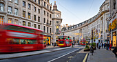 View of red buses and shops on Regent Street at Christmas, London, England, United Kingdom, Europe