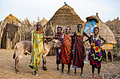 Women with a donkey in front of their hut, Jiye tribe, Eastern Equatoria State, South Sudan, Africa