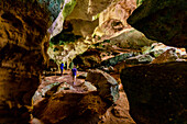 People exploring sea caves on North Caicos, Turks and Caicos Islands, Atlantic, Central America
