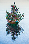 USA, Massachusetts, Nantucket Island. Nantucket Town, small dory with Christmas tree.