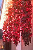 USA, New Mexico, Santa Fe: Canyon Road Gallery District Chili Pepper Ristra Wreaths & Lights