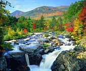 USA, New York. A waterfall in the Adirondack Mountains, part of Flume Falls from the Ausable River, mountain in the background is Whiteface Mountain