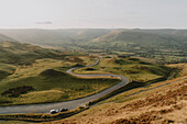 Winding road through rural, idyllic, sunny landscape, Castleton, Derbyshire, England