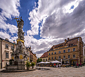 Holy Trinity Column and terrace cafe on the main square in Baden near Vienna, Lower Austria; Austria