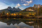 Three Sisters reflect into pool in Canmore, Alberta, Canada