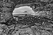 Canada, Newfoundland, The Arches Provincial Park, Rock cave on shore of Gulf of St. Lawrence