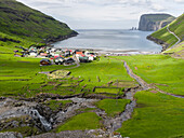 Village Tjornuvik. In the background the island Eysturoy with the iconic sea stacks Risin and Kellingin. Denmark, Faroe Islands